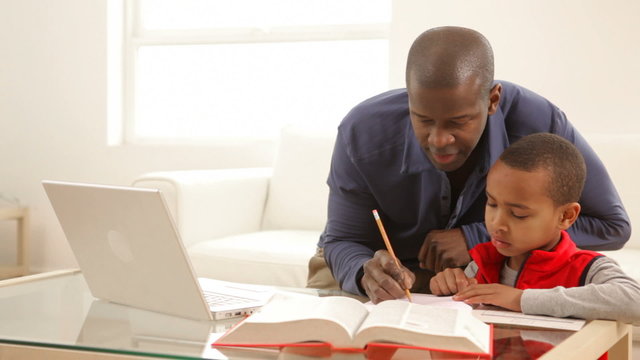 Father and son working on homework together