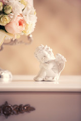figurine of an angel and pink bridal bouquet