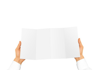 Hand in white shirt holding blank leaflet in the hand. 