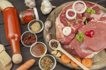 Raw beef shin and vegetables. Sales of beef. Preparing meat for cooking. Raw meat on a cutting board ready for cutting. Preparing the menu.
