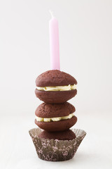 Chocolate whoopie pies with buttercream filling with birthday candle