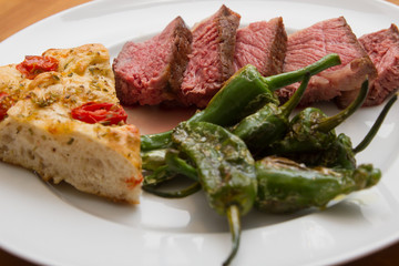 Steak with pimentos de padron and focaccia bread
