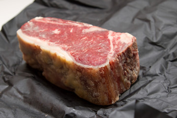 Raw dry aged t-bone steak