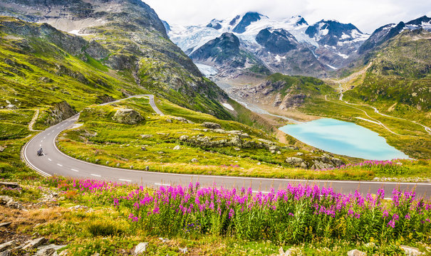 Motorcyclist On Mountain Pass Road In The Alps