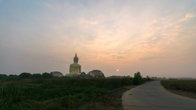 Buddha statue with sunshine in Thai temple, Timelapse