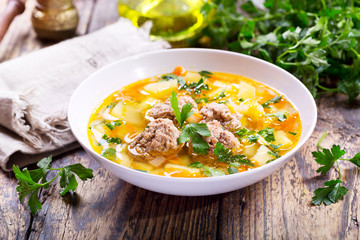plate of soup with meatballs