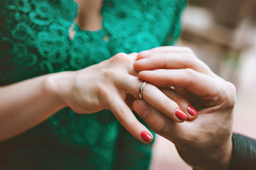 The groom wears the ring bride. the man wears the ring to the woman. Engagement.