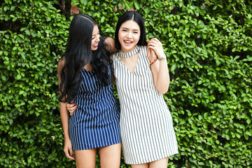 Two happy and lively female best friends having a good time together
