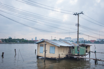 Poor hut on riverside, taken from Bangkok Thailand