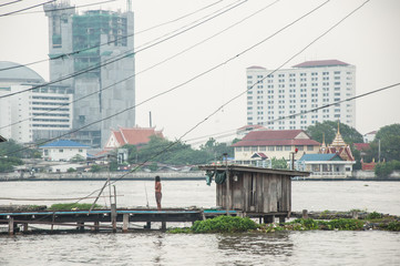Poor hut on riverside, taken from Bangkok Thailand