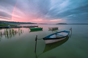 Dramatic sunset on the lake with rainbow
