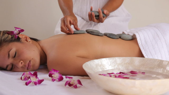 Woman gets hot stone spa treatment