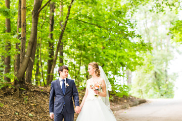 happy bride and groom at a park on their wedding day
