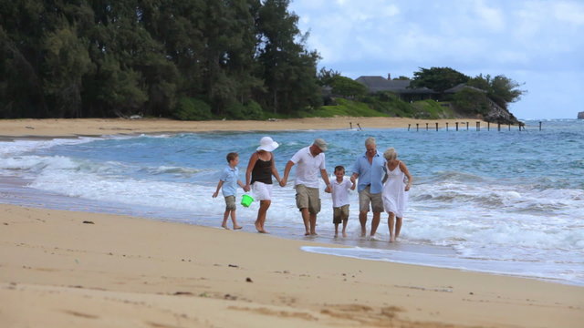 Multi-generation family walking together at beach