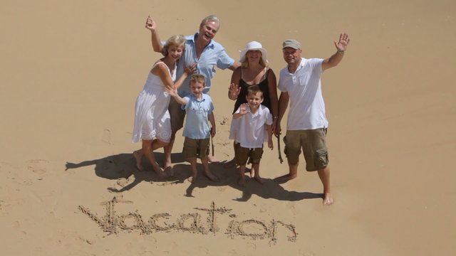 Multi-generation family writes VACATION in the sand