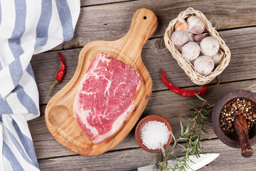 Raw beef steak with spices and herbs