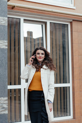 Beautiful girl with a phone in town
