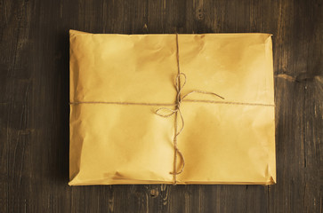 Vintage craft paper envelope tied up with string. Toned image. Top view