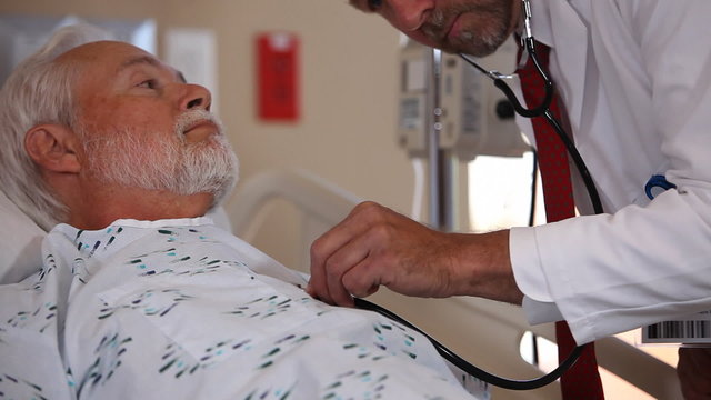 Doctor checks senior patient with stethoscope