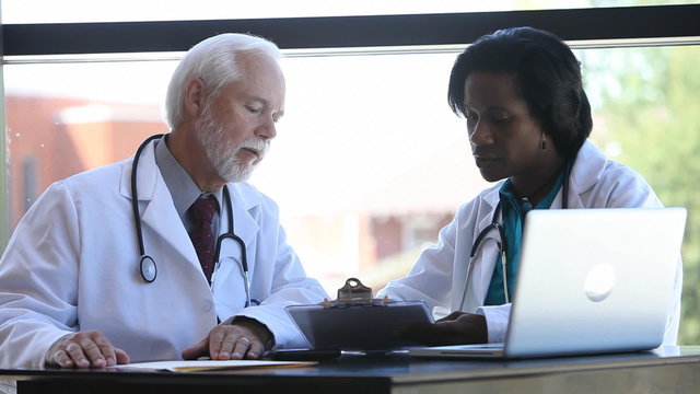 Doctors talking over charts