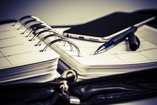 planning concept - calendar, cellphone, pen