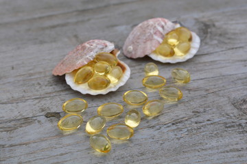 Scattered cod liver oil on wooden texture