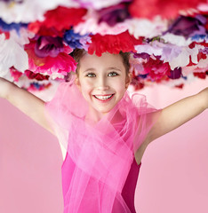 Obraz na płótnie Canvas Cheerful girl with a flower hat