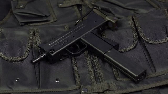 Mac-11 against the background of the vest