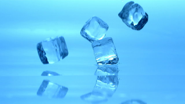 Ice cubes falling, slow motion