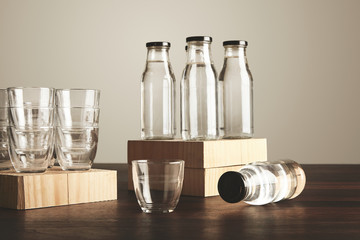 Closeup set glasses bottles water on wooden table