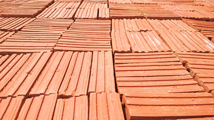 Obraz na płótnie Canvas Stack of red clay bricks (16:9)