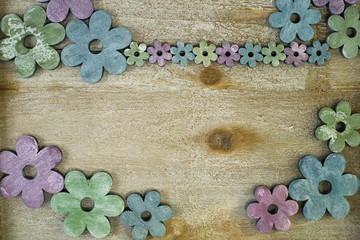 Fototapeta na wymiar Colorful wooden flowers on wooden background, decoration