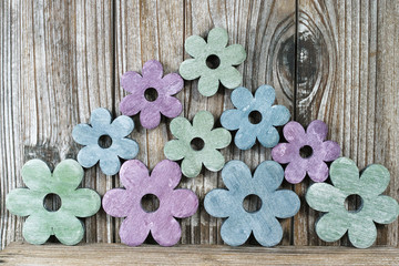 Colorful wooden flowers on wooden background, decoration