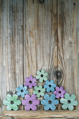 Colorful wooden flowers on wooden background,  copy space