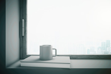 Window with gray coffee cup and book