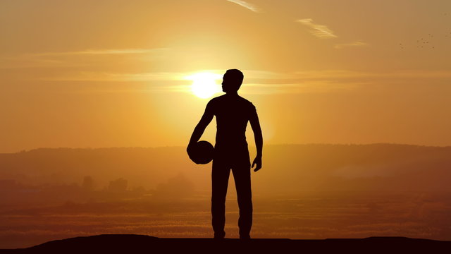 The man stand with a ball on the background of sunset. Time lapse
