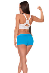 Obraz premium Fitness woman in sport style standing against isolated white background