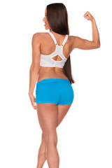 Fototapeta premium Fitness woman in sport style standing against isolated white background