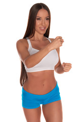 Fitness woman in sport style standing against isolated white background