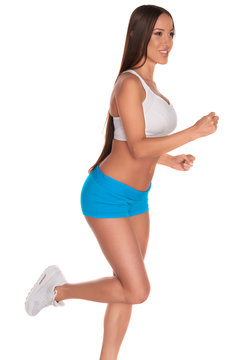 Fitness woman in sport style standing against isolated white background