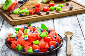 Watermelon salad with kiwi fruit, blueberries and fresh mint lea