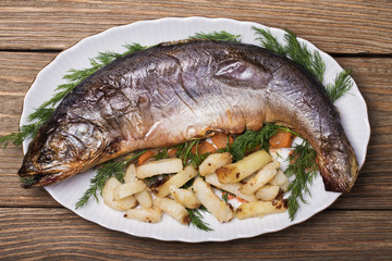 Baked fish and chips and dill, top view