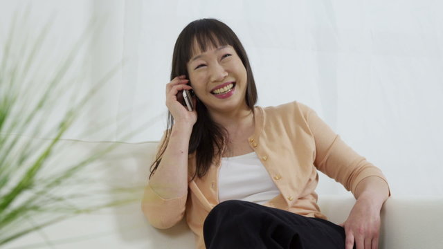 Asian woman talking on phone