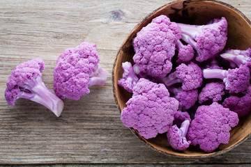 Rainbow of eco cauliflower on the wooden table.