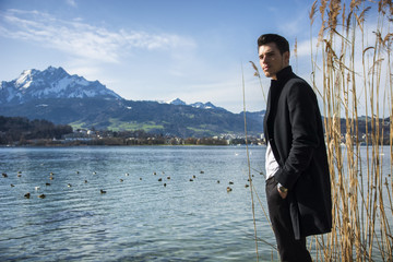 Naklejka premium Handsome young man on Luzern lake's shore