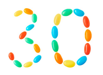 30 number made of multicolored candies isolated on white
