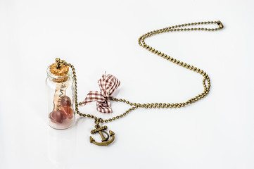 Pendant made with glass bottle, antique gold chain and amber iso