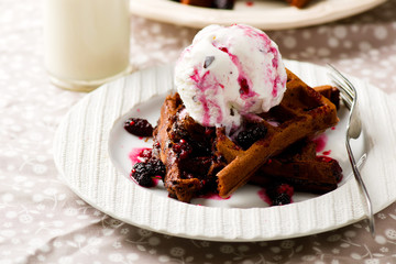  chocolate waffle with ice cream and berry sauce