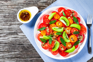 tomato salad with kiwifruit, dressing olive oil with aromatic he