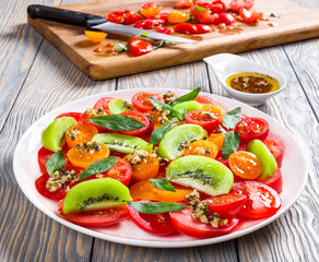 tomatoes, kiwi fruit, mint salad dressed with shredded cheese br
